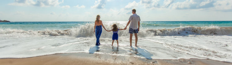 Family Holding Hands on Beach